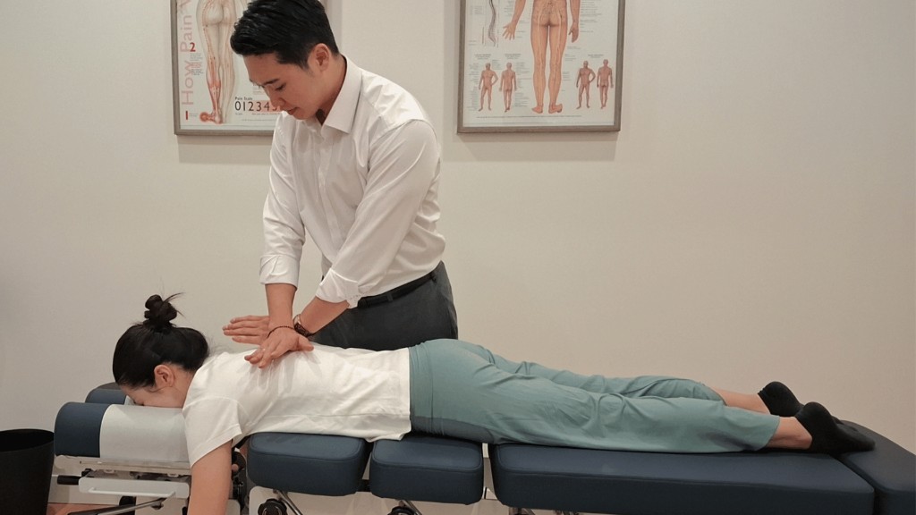 Chiropractor adjusting a patient on a treatment table
